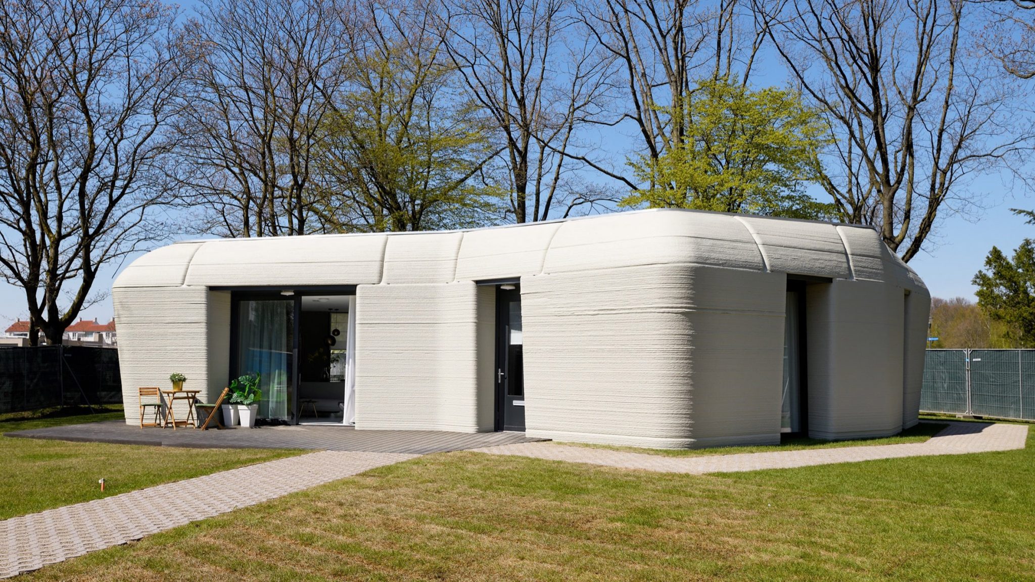 A boulder-shaped concrete house in the Netherlands has become the first lived-in 3D-printed home in the country after its tenants received the key on April 30.

Located in a suburb of Eindhoven, the single-storey home was built as part of a five-home 3D printing scheme named Project Milestone, and is said to be the first 3D-printed home in Europe where people actually live.
